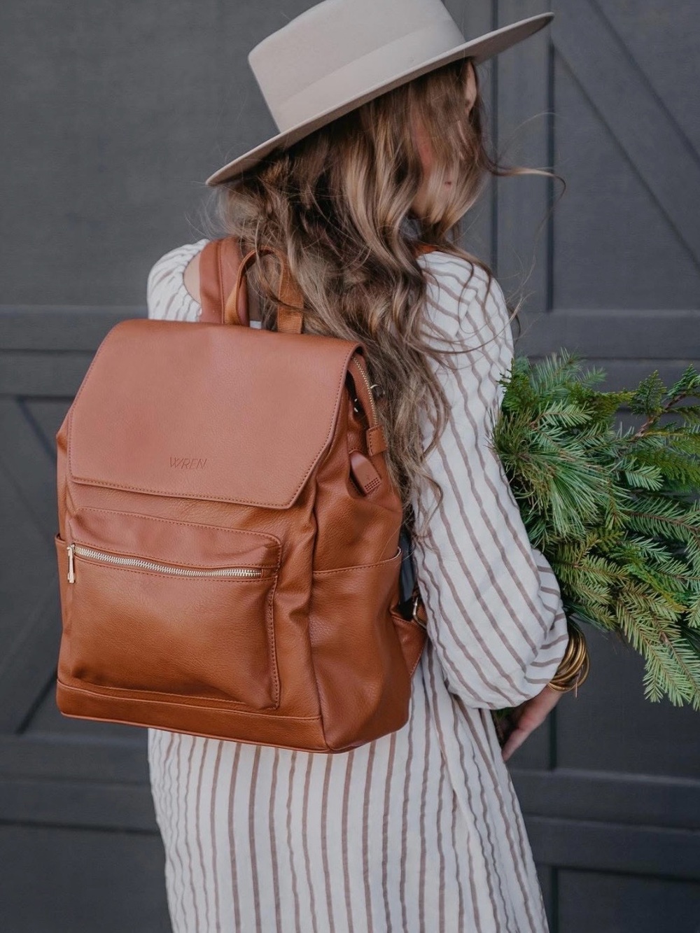 Wren Bag Vegan Leather Diaper Bag Backpack in the color Cognac